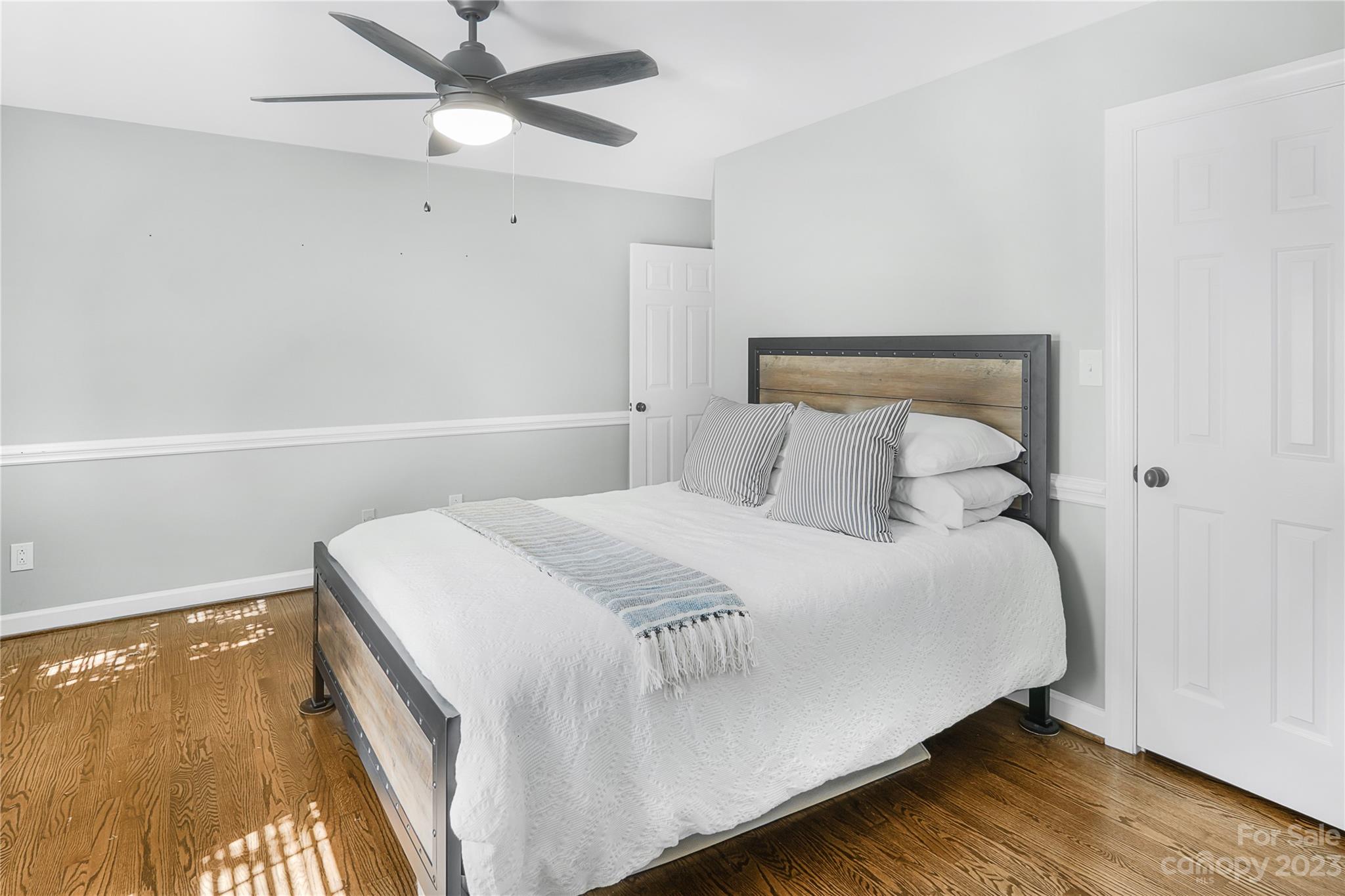 4339 Quail View Road Charlotte, NC 28226 - Photo 30 of 40 a bedroom with a bed and a ceiling fan