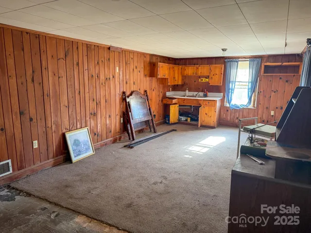 a view of a room with furniture and a window