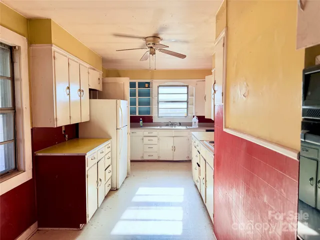 a kitchen with a sink stove and refrigerator