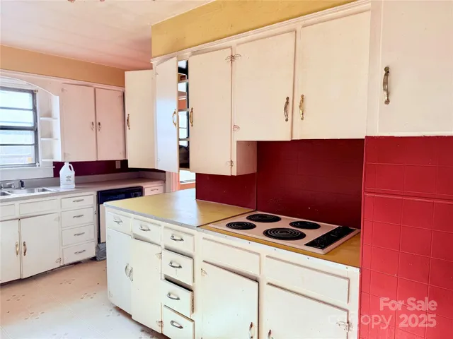a kitchen with a cabinets and white appliances