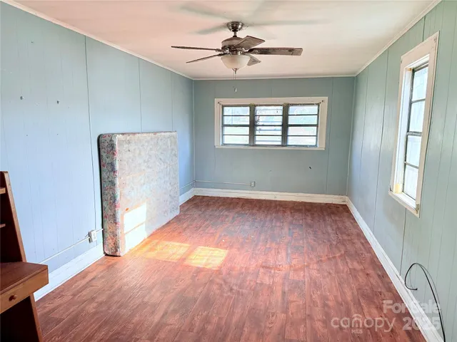 wooden floor in an empty room with a window
