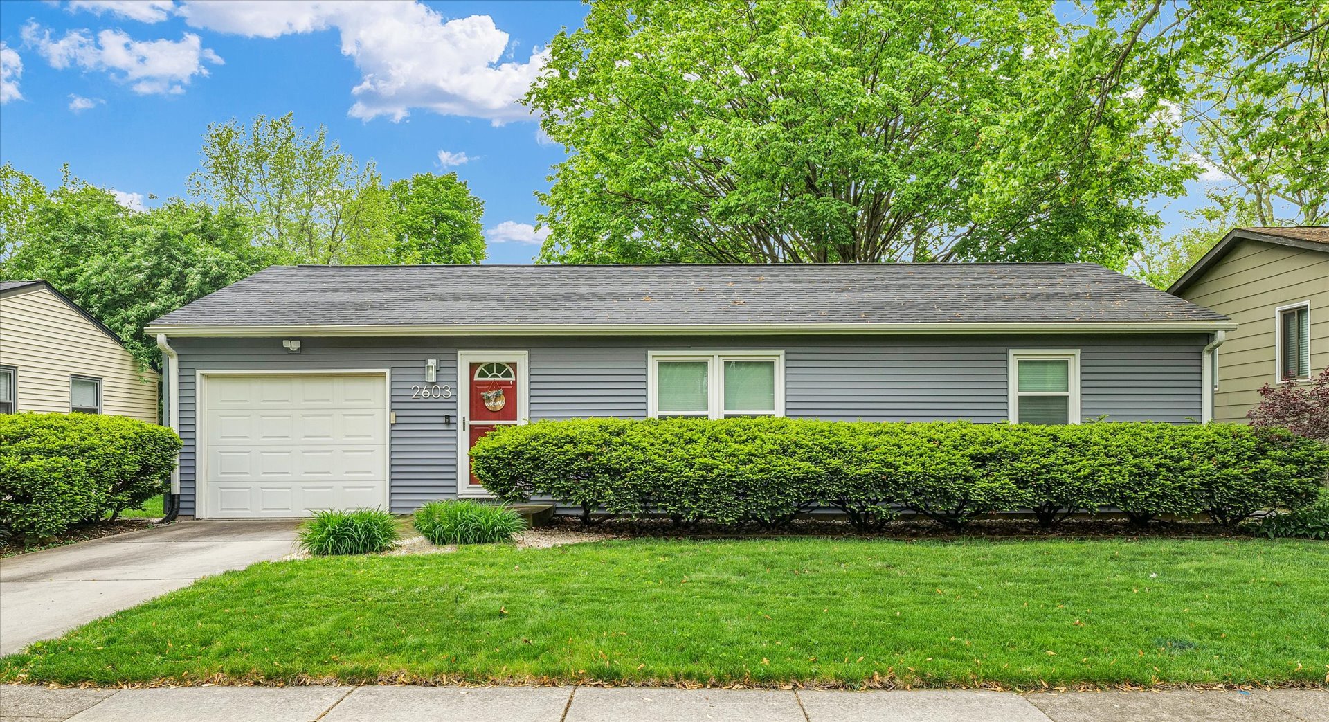 2603 Trafalgar Square Champaign, IL 61821 - Photo 1 of 32 a front view of a house with a yard and garage