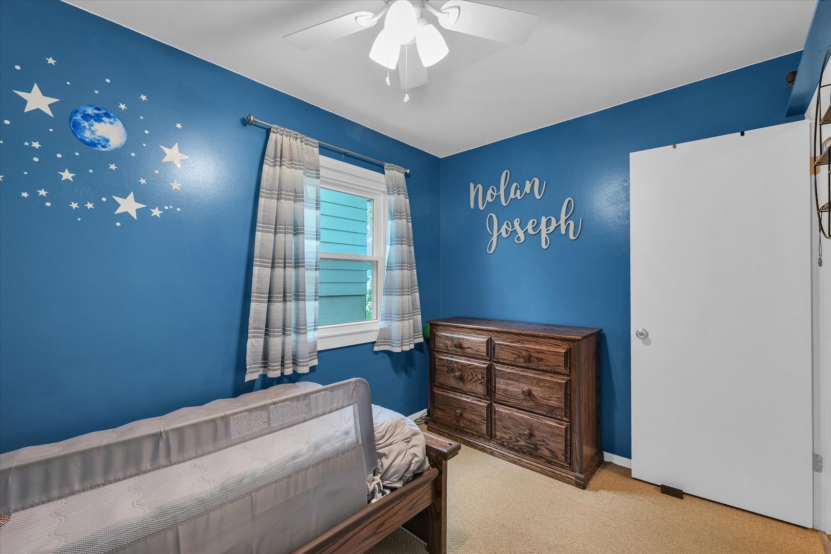 2603 Trafalgar Square Champaign, IL 61821 - Photo 19 of 32 a bedroom with a bed and a chandelier