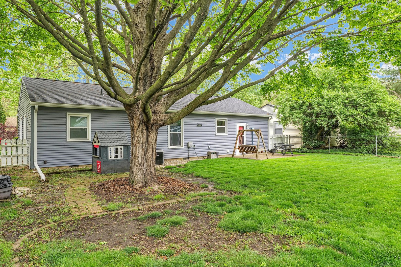 2603 Trafalgar Square Champaign, IL 61821 - Photo 26 of 32 a view of a house with backyard and a tree