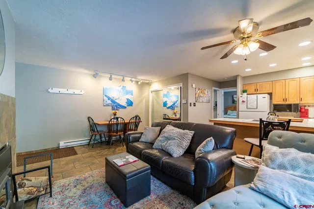 a living room with furniture and a chandelier