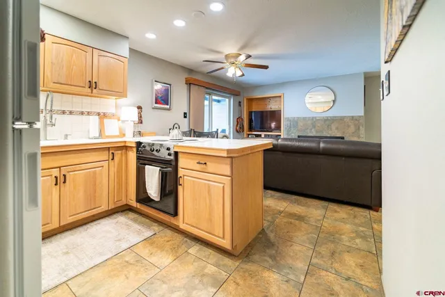 a kitchen with a stove sink and cabinets