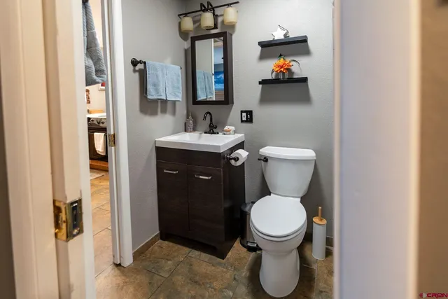 a bathroom with a toilet sink and mirror