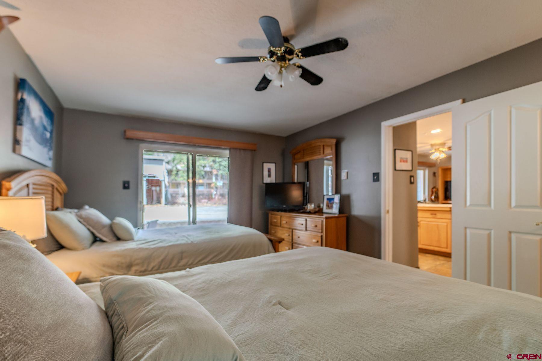 395 Sheol Street, Unit 26 Durango, CO 81301 - Photo 19 of 30 a bedroom with a bed and wooden floor
