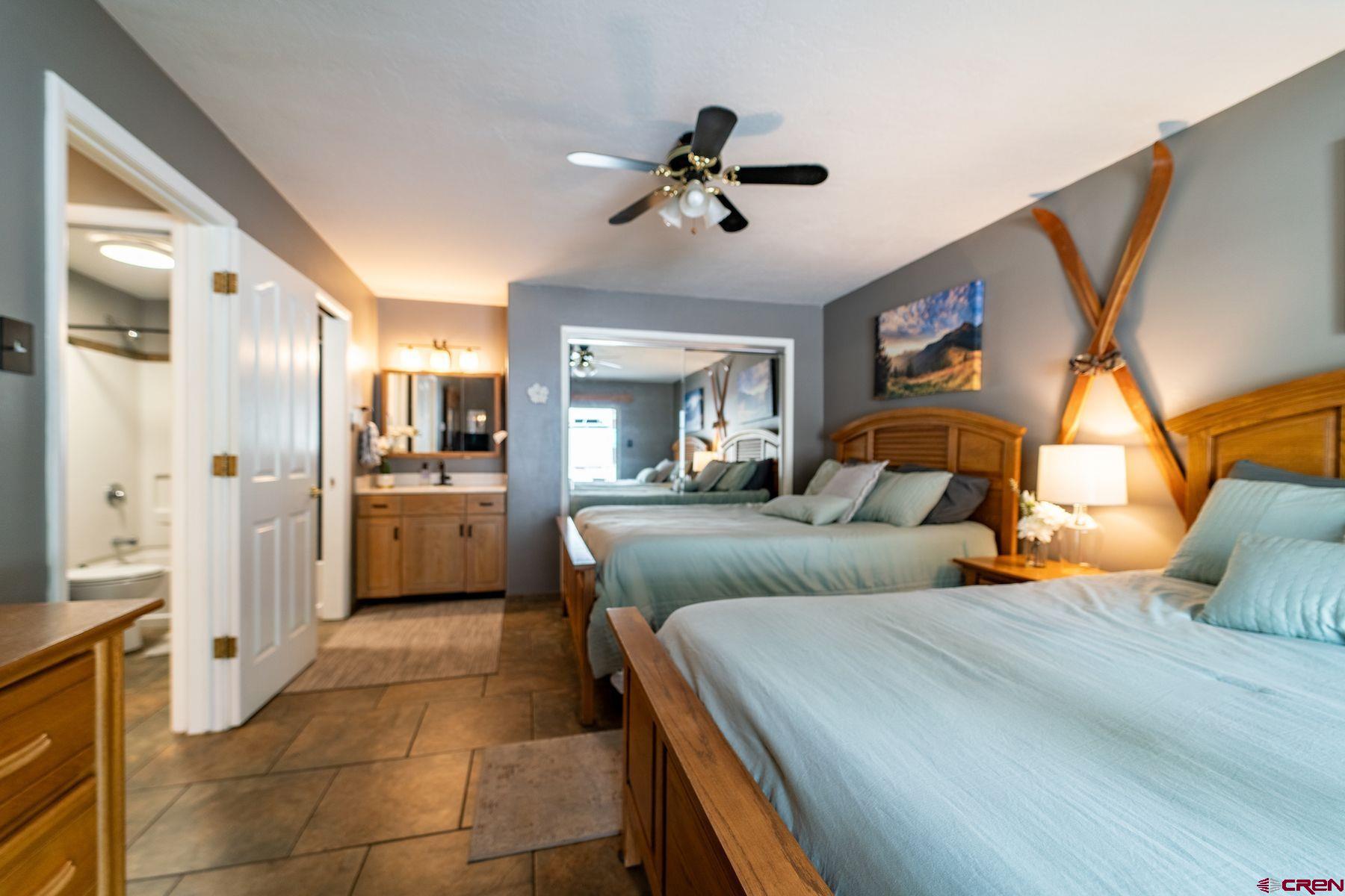 395 Sheol Street, Unit 26 Durango, CO 81301 - Photo 4 of 30 a bedroom with a bed and ceiling fan