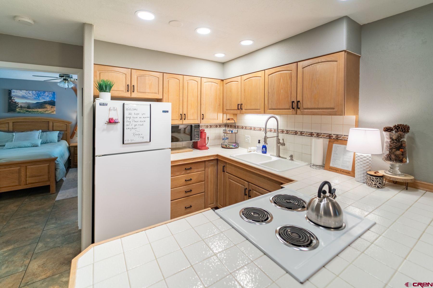 395 Sheol Street, Unit 26 Durango, CO 81301 - Photo 5 of 30 a kitchen with sink refrigerator and stove