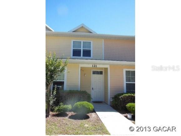 1609 Northwest 29 Road, Unit C121 Gainesville, FL 32605 - Photo 1 of 1 a view of a brick house with plants