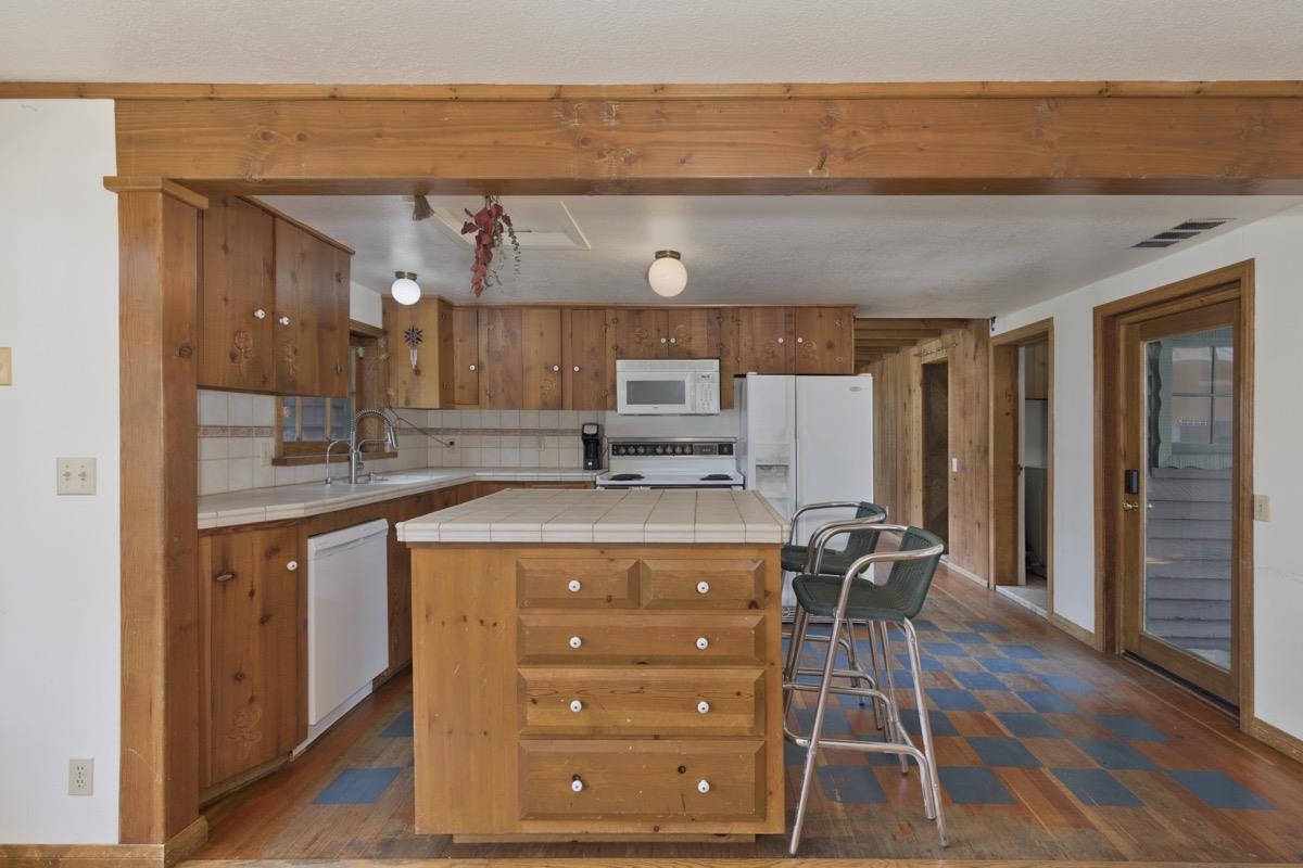 2030 Old Mammoth Road Mammoth Lakes, CA 93546 - Photo 7 of 46 a kitchen that has a cabinets and a table in it