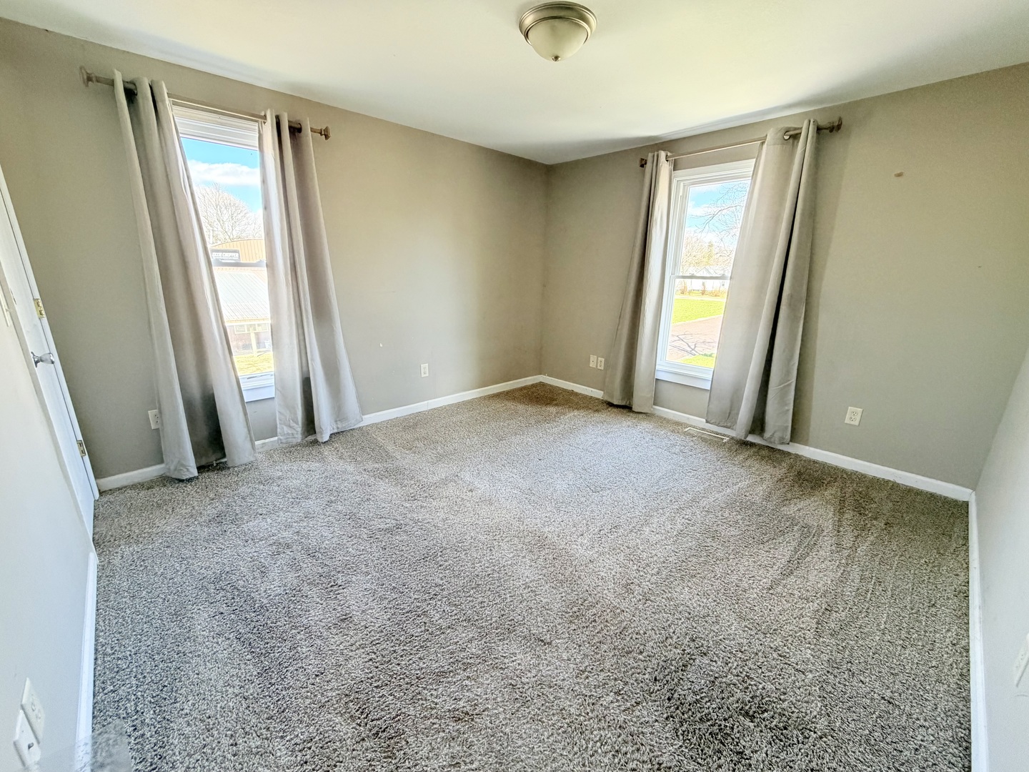 608 West Cedar Street Le Roy, IL 61752 - Photo 11 of 17 an empty room with windows