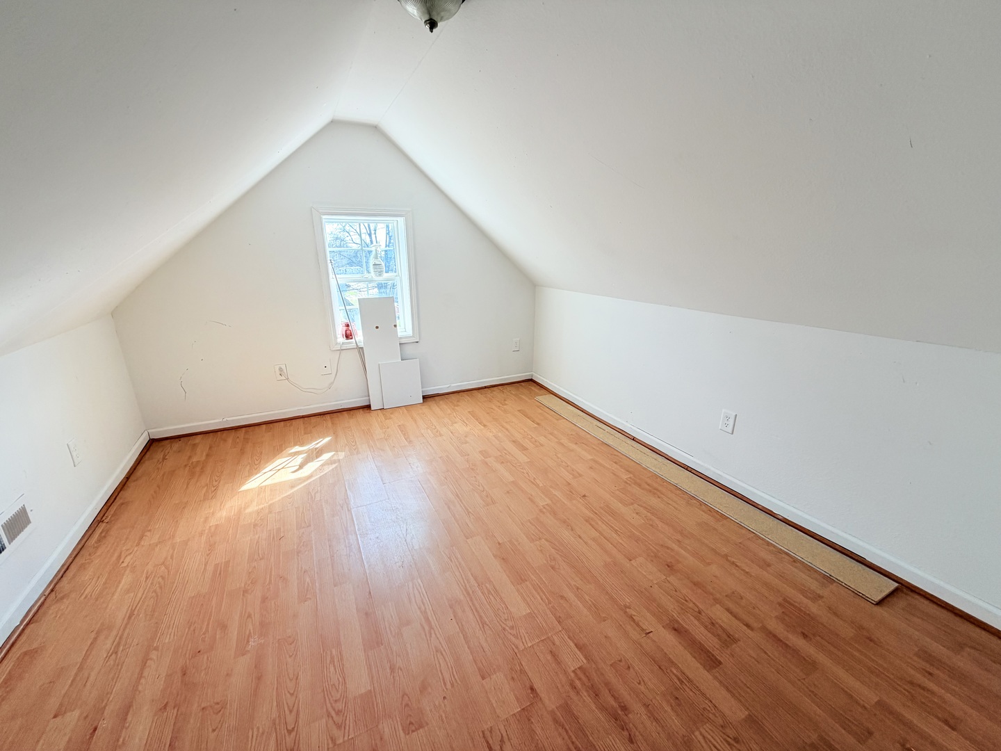 608 West Cedar Street Le Roy, IL 61752 - Photo 15 of 17 an empty room with wooden floor and windows
