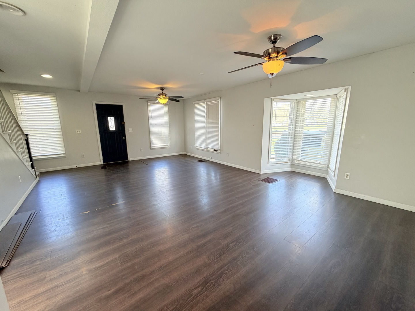 608 West Cedar Street Le Roy, IL 61752 - Photo 2 of 17 a view of an empty room with a window and wooden floor