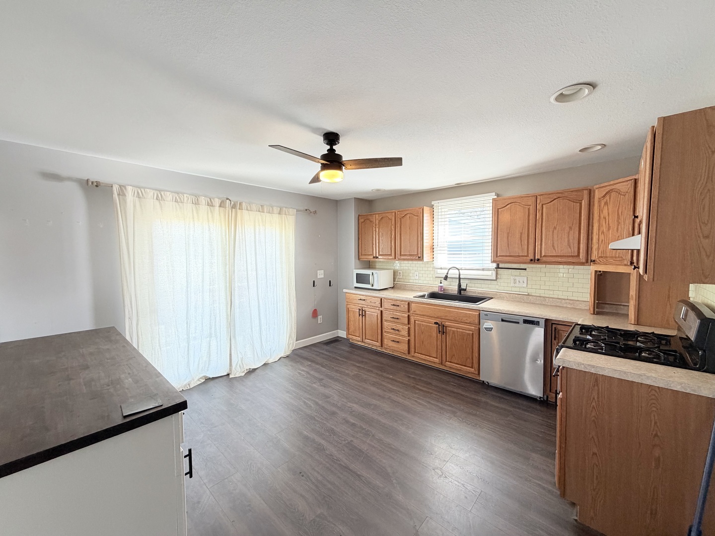 608 West Cedar Street Le Roy, IL 61752 - Photo 6 of 17 a kitchen with granite countertop a sink cabinets and wooden floor