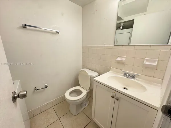 a bathroom with a sink toilet and a mirror