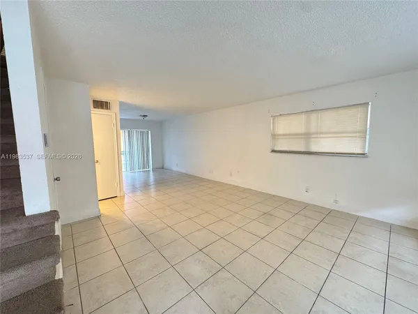 an empty room with windows and entrance