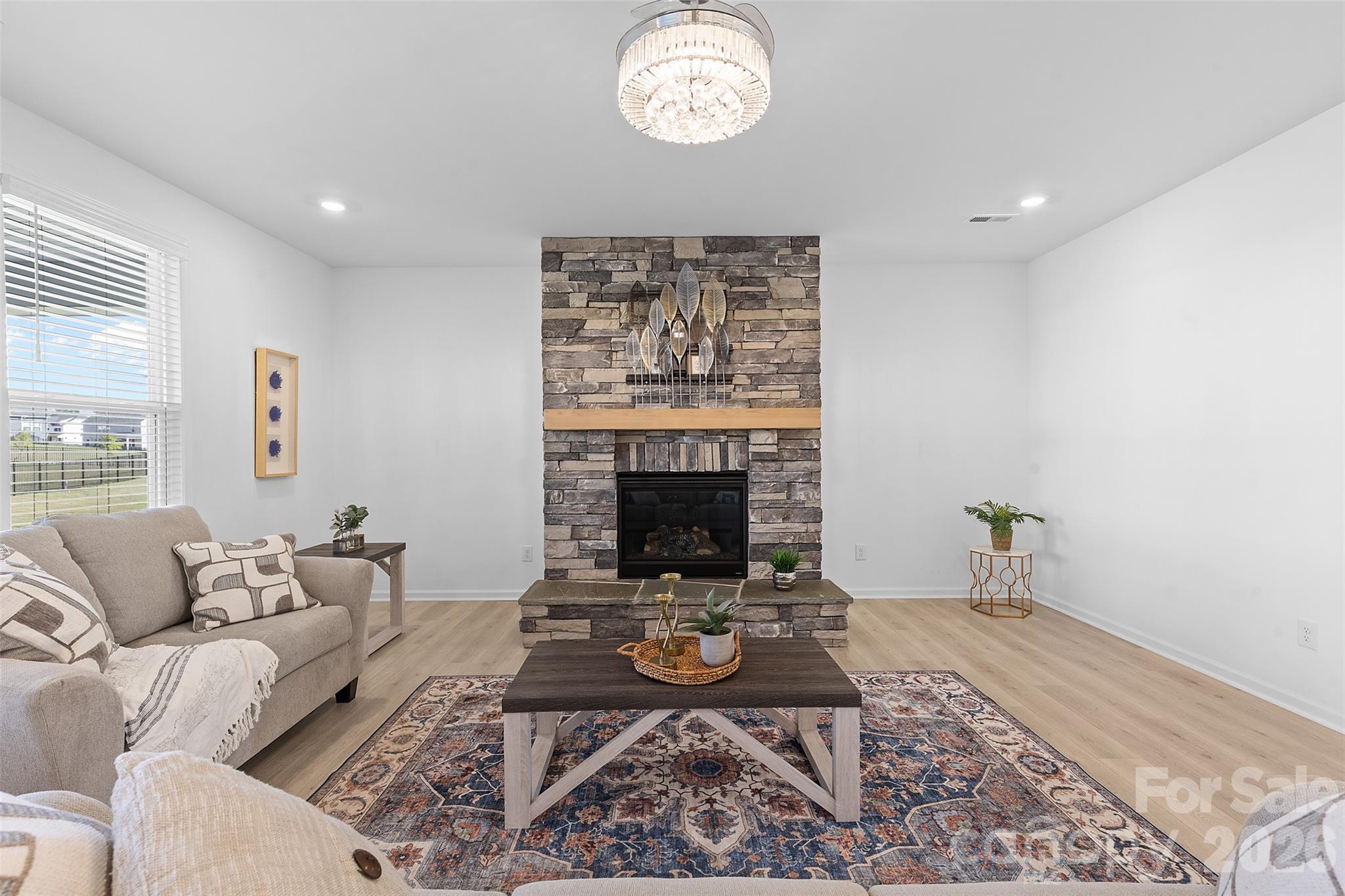 1170 Sugar Crk Road Fort Mill, SC 29707 - Photo 13 of 47 a living room with furniture a rug and a fireplace