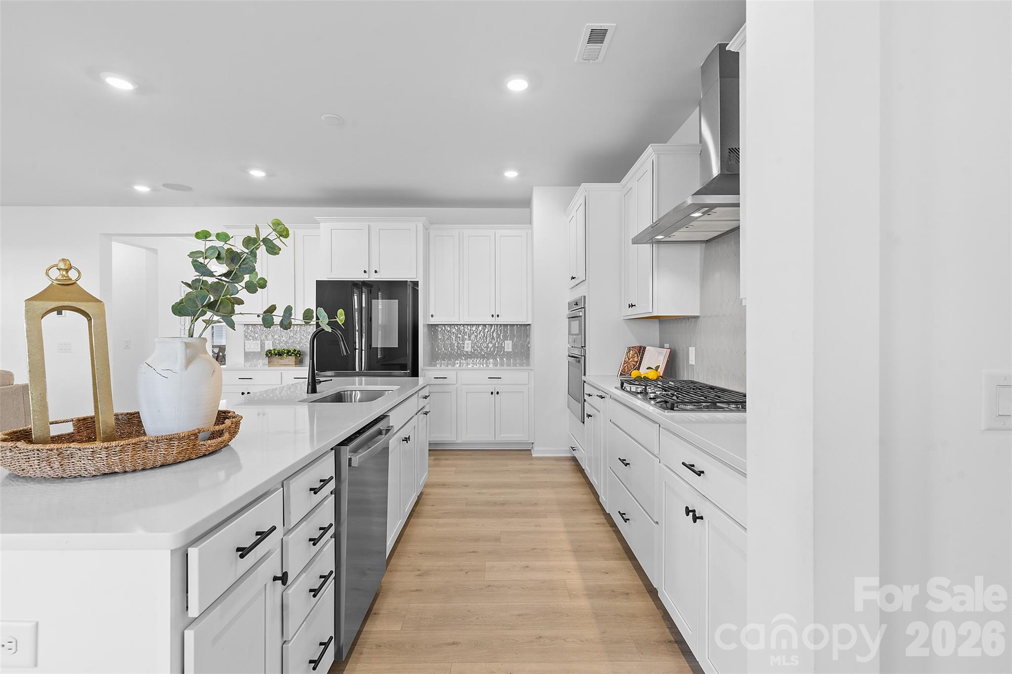1170 Sugar Crk Road Fort Mill, SC 29707 - Photo 17 of 47 a large kitchen with stainless steel appliances kitchen island granite countertop a sink and cabinets