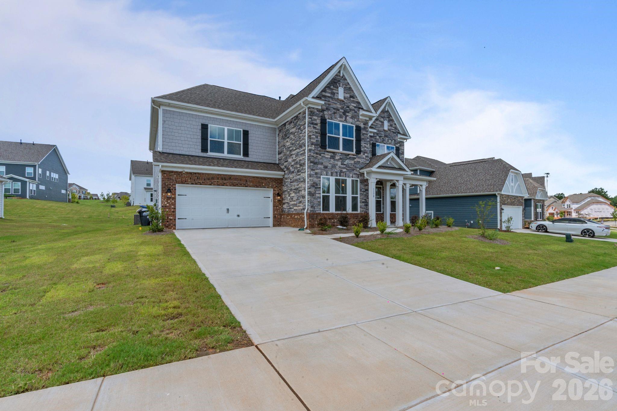 1170 Sugar Crk Road Fort Mill, SC 29707 - Photo 4 of 47 a front view of a house with a yard and garage