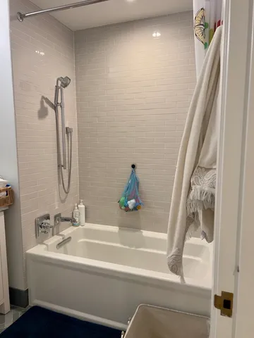 a bathroom with a tub sink and vanity