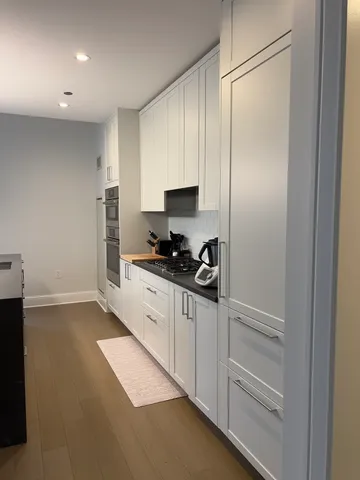 a kitchen with granite countertop cabinets and refrigerator