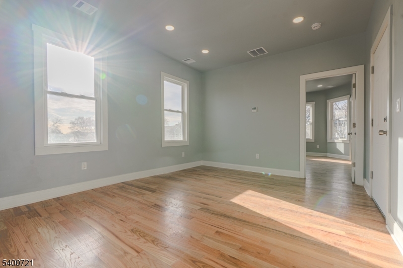 882 South 14th Street, Unit 3 Newark, NJ 07108 - Photo 14 of 20 an empty room with wooden floor and windows