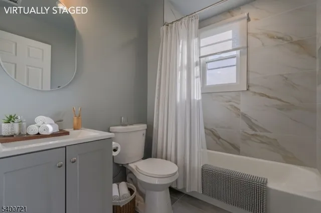a bathroom with a granite countertop toilet a sink and a bathtub