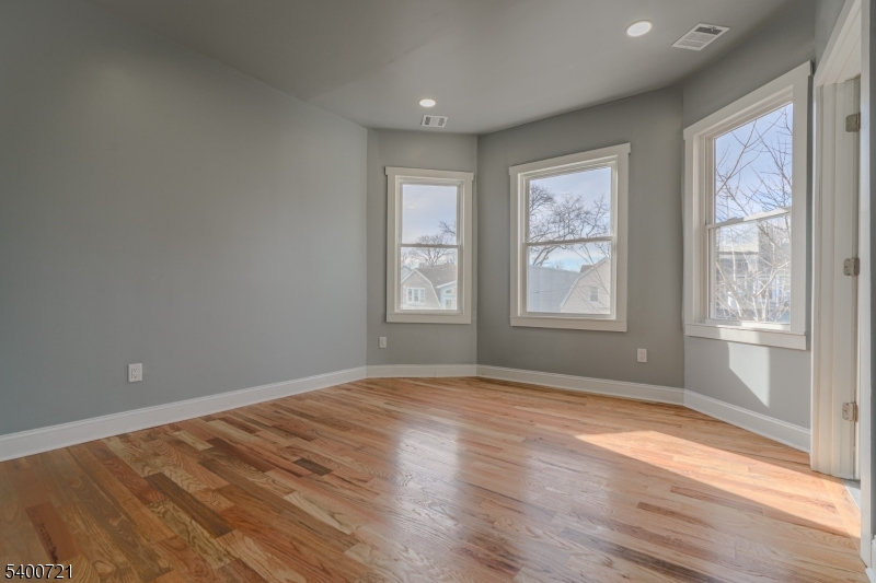 882 South 14th Street, Unit 3 Newark, NJ 07108 - Photo 2 of 20 a view of empty room with wooden floor and fan