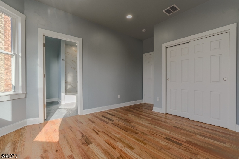882 South 14th Street, Unit 3 Newark, NJ 07108 - Photo 3 of 20 a bedroom with a bed and a window