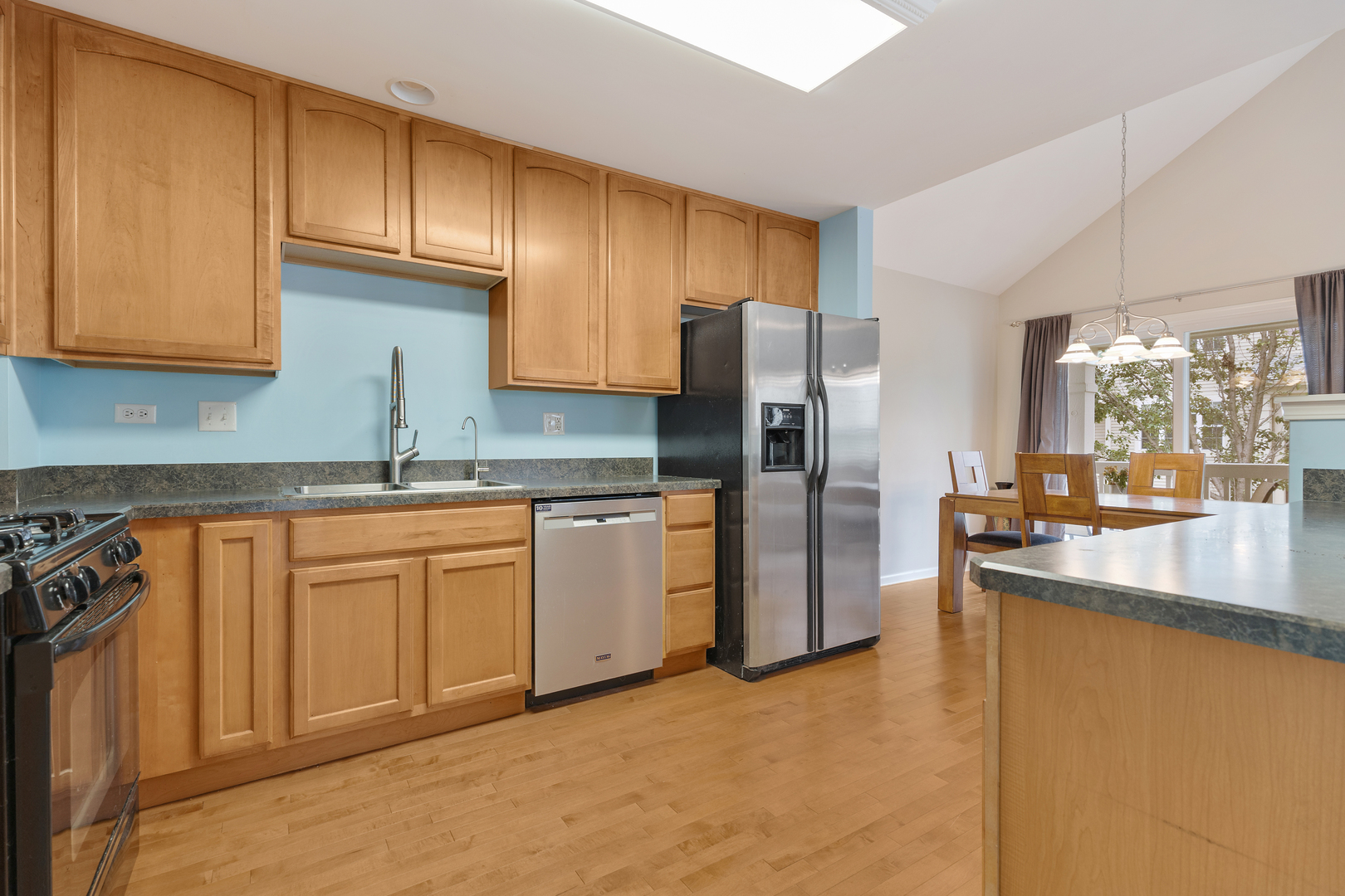 1641 Sandcastle Lane Pingree Grove, IL 60140 - Photo 4 of 15 a kitchen with granite countertop a refrigerator a sink a stove and cabinets