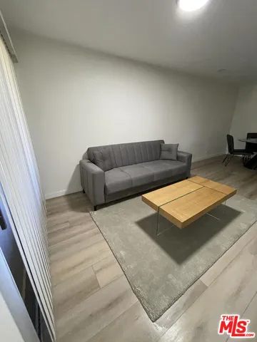 a living room with a couch and a wooden floor