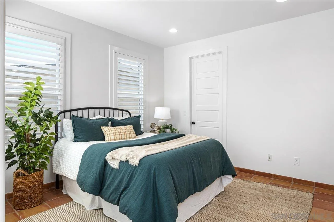 1066 Melba Road Encinitas, CA 92024 - Photo 15 of 54 a bedroom with a bed and a potted plant