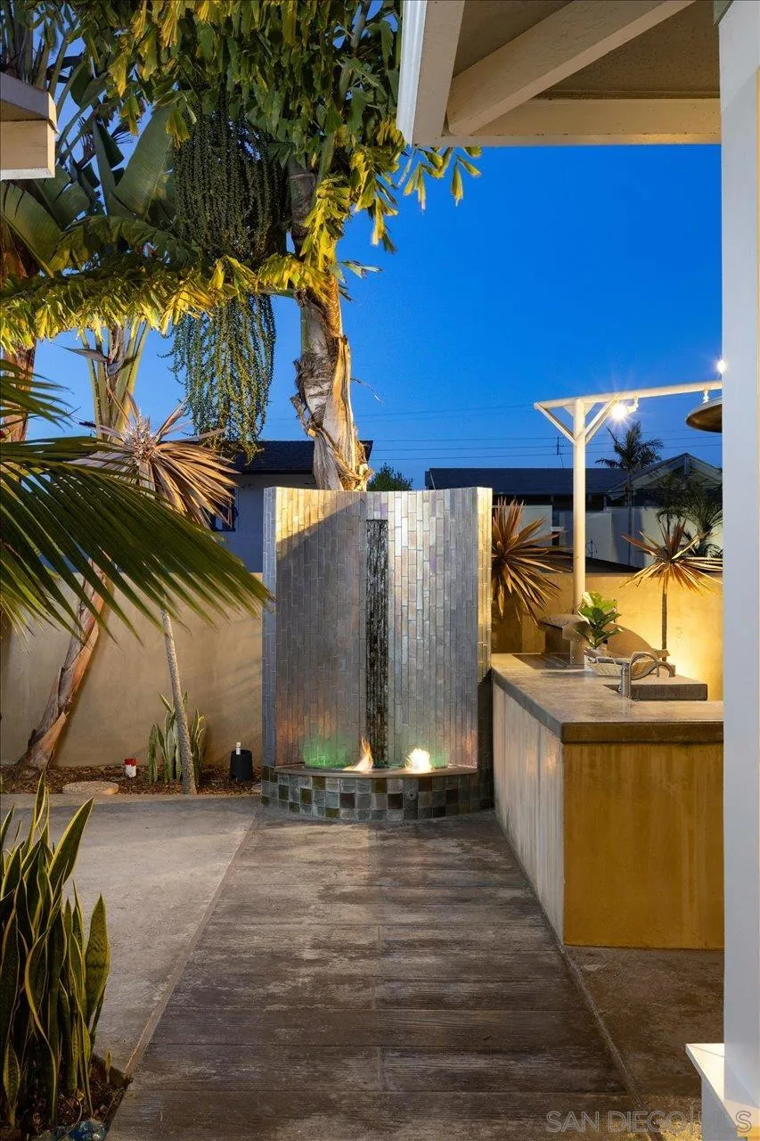 1066 Melba Road Encinitas, CA 92024 - Photo 18 of 54 a view of a patio with table and chairs under an umbrella