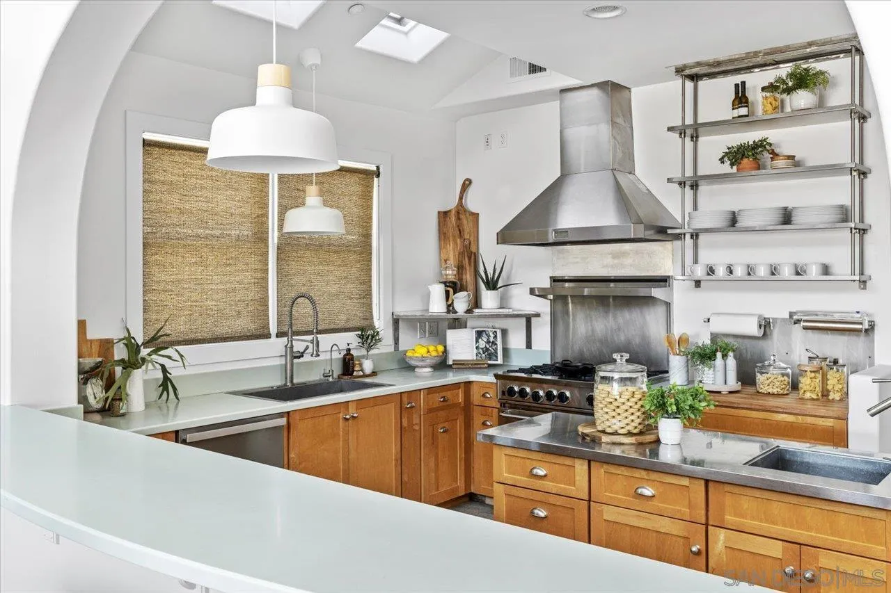1066 Melba Road Encinitas, CA 92024 - Photo 24 of 54 a kitchen with stainless steel appliances a sink a stove and a wooden floor