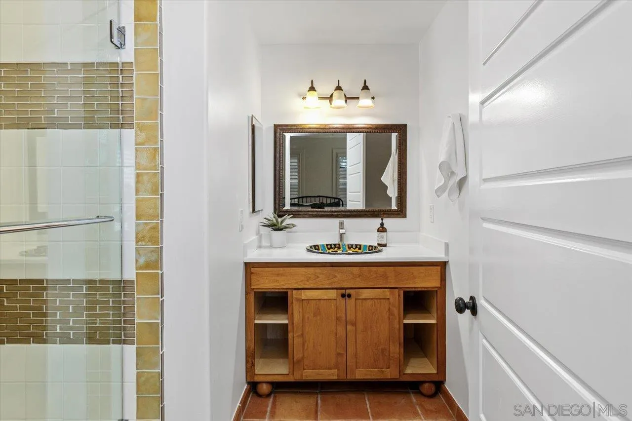 1066 Melba Road Encinitas, CA 92024 - Photo 28 of 54 a bathroom with a sink and a mirror