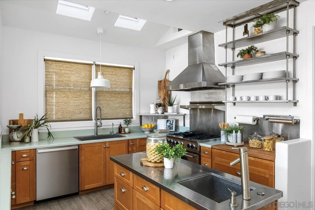 1066 Melba Road Encinitas, CA 92024 - Photo 8 of 54 a kitchen with stainless steel appliances granite countertop a sink a stove and a wooden cabinets