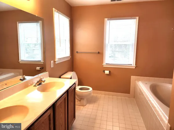 a bathroom with a sink a bathtub and window