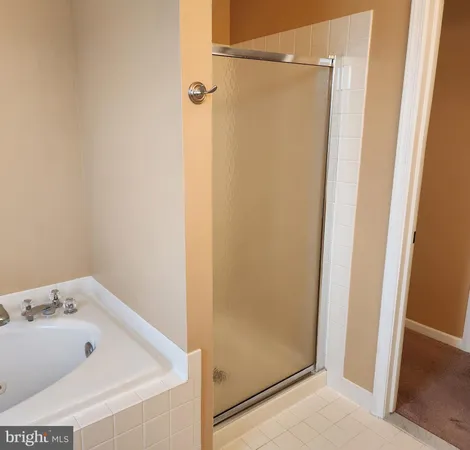 a bathroom with a tub and shower