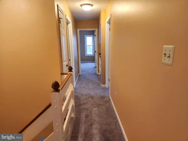 a view of a bathroom from a corridor