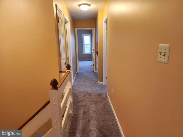 a view of a bathroom from a corridor