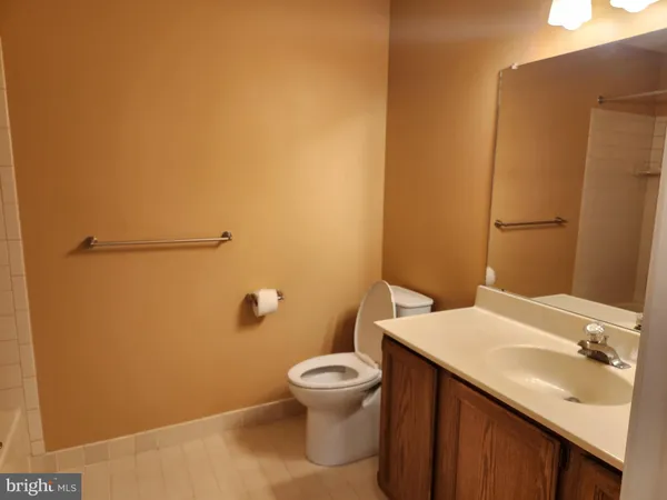 a bathroom with a sink and mirror with toilet