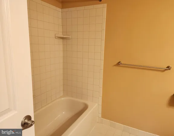 a bathroom with a shower and a bath tub
