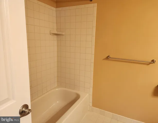 a bathroom with a shower and a bath tub
