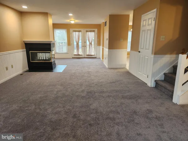 a view of an empty room with a fireplace