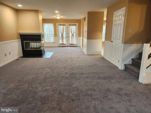 a view of an empty room with a fireplace