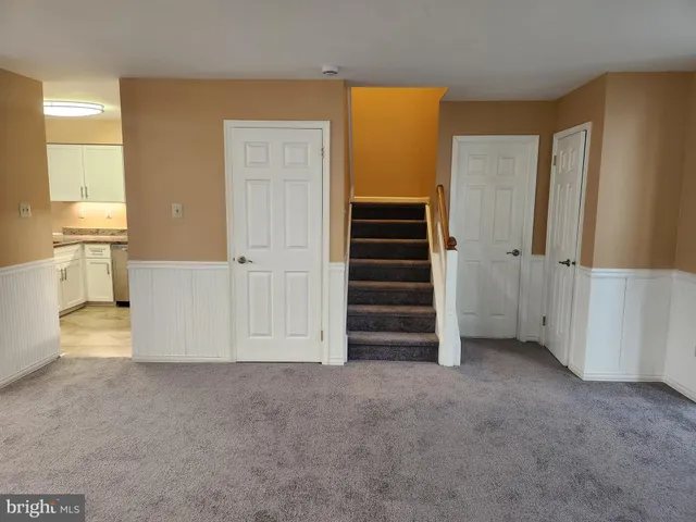 an empty room with a cabinet and mirrors