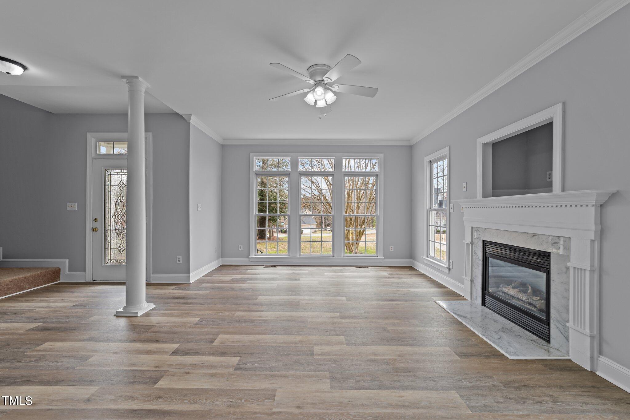 3525 La Costa Way Raleigh, NC 27610 - Photo 9 of 45 a view of an empty room with a fireplace and a window