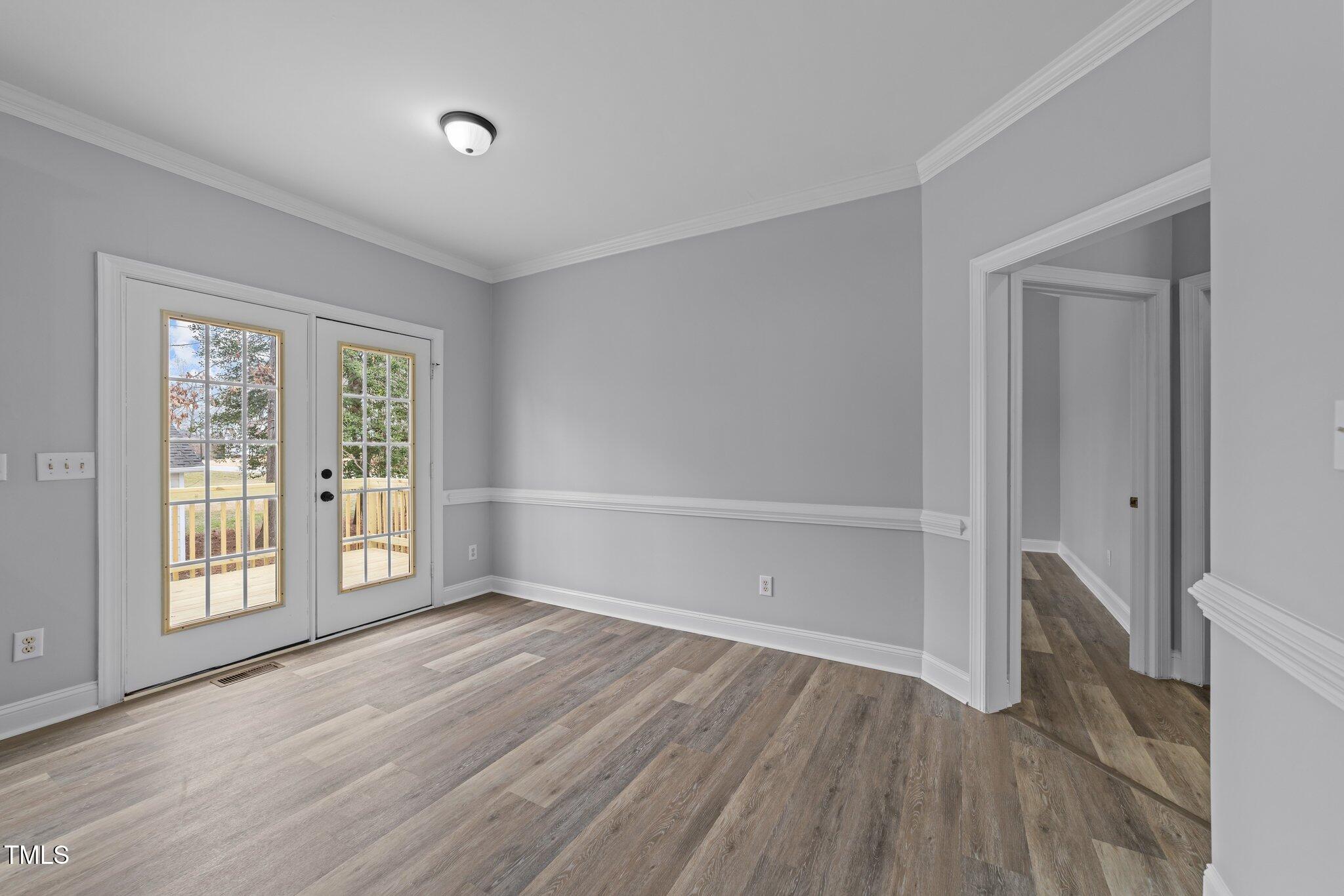 3525 La Costa Way Raleigh, NC 27610 - Photo 10 of 45 an empty room with wooden floor and windows